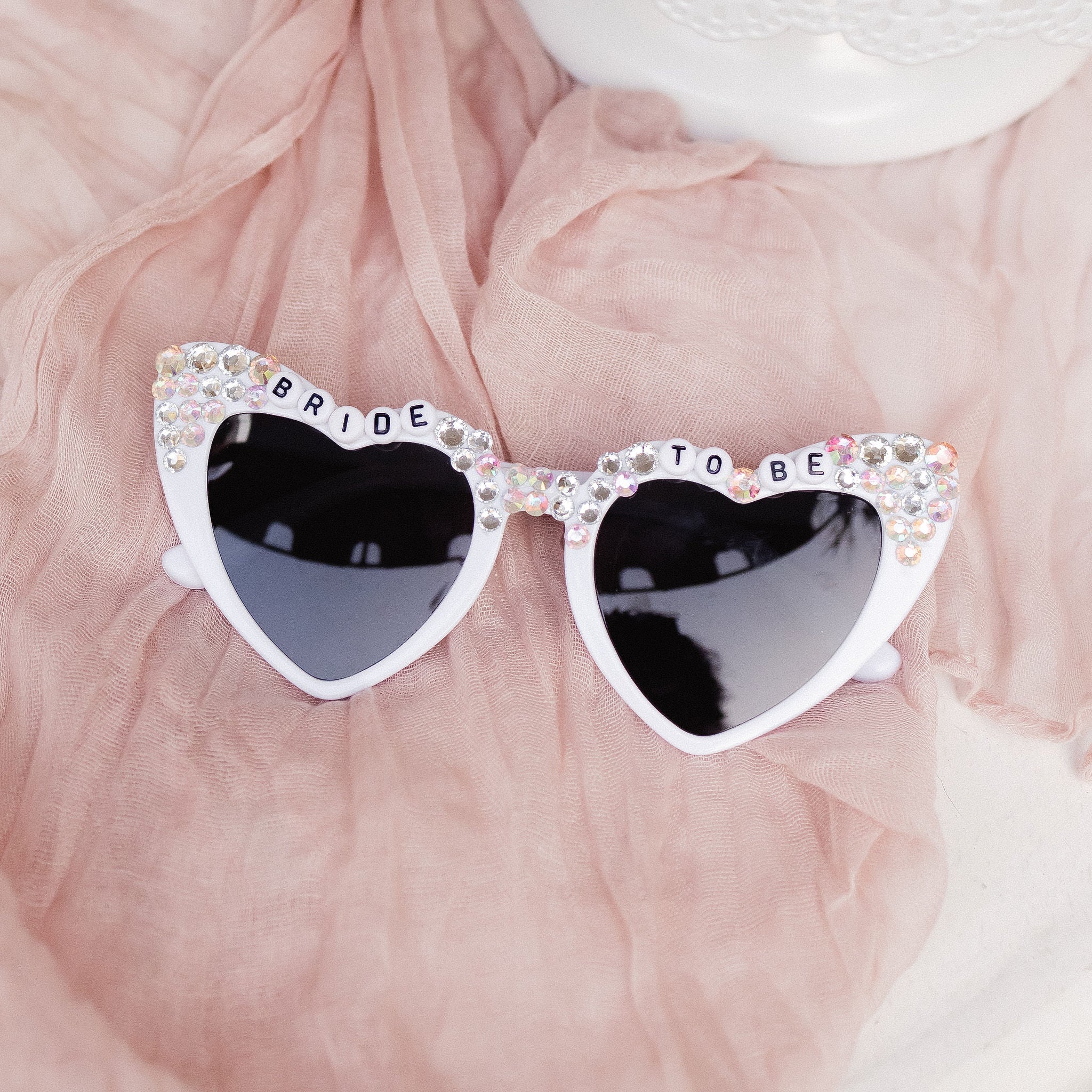 Shine bright on your bachelorette party or bridal celebrations with these Bride-to-Be Rhinestone Sunglasses.