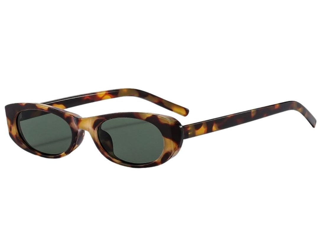 A slim, minimal frame Sunglasses with tortoiseshell frame and dark lenses 