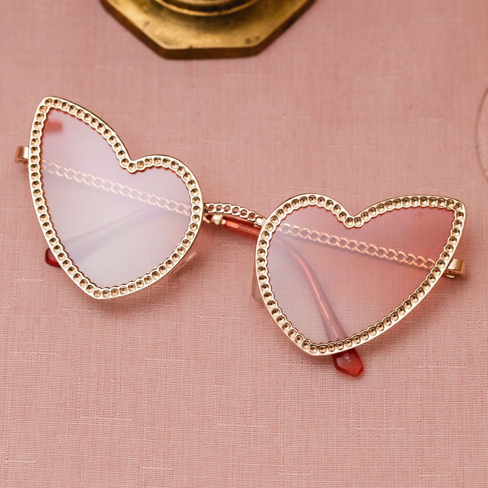 BELOVED Sunglasses with heart wings frame, lightweight polycarbonate and copper design, UV protection – bold festival and party statement shades.
