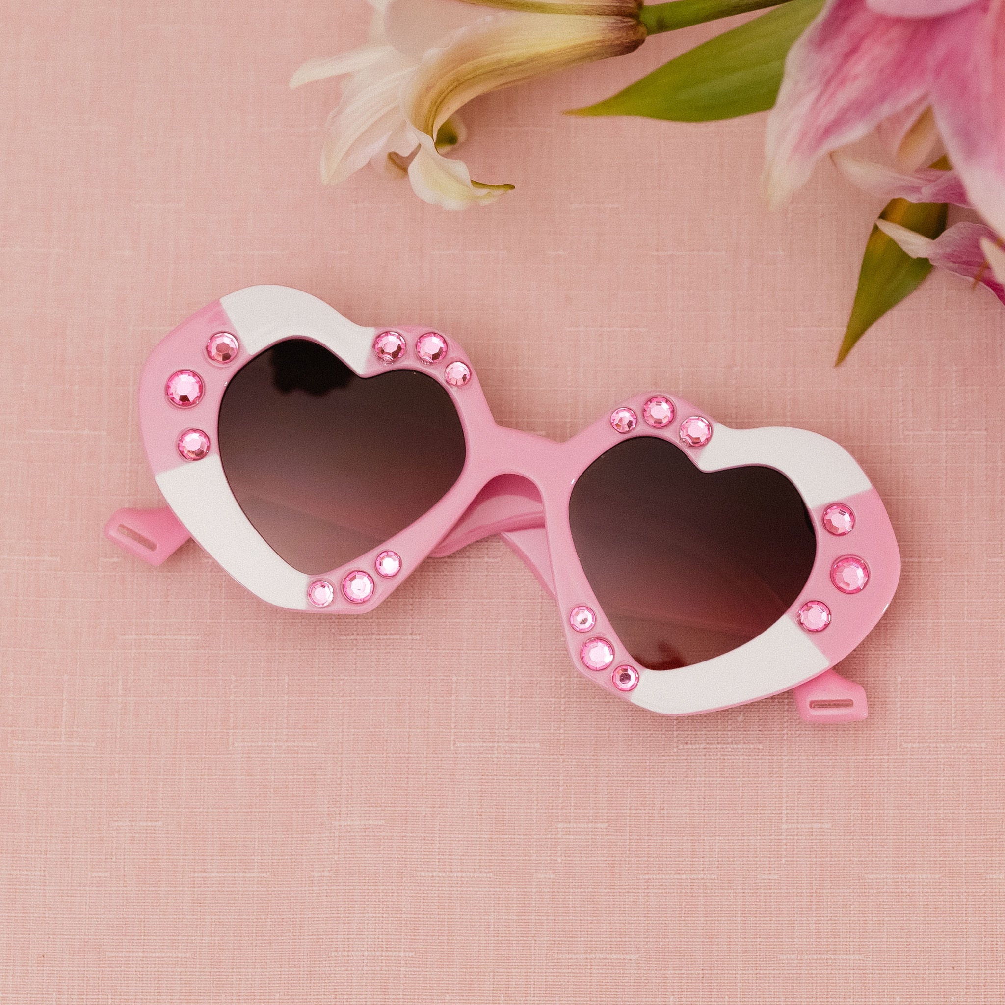 Fun and flirty DOLLIE sunglasses with pink rhinestone details and UV protection